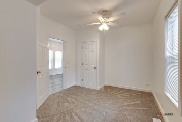 empty room with carpet flooring and ceiling fan