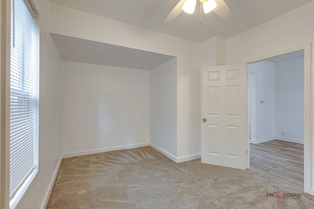 carpeted empty room with ceiling fan