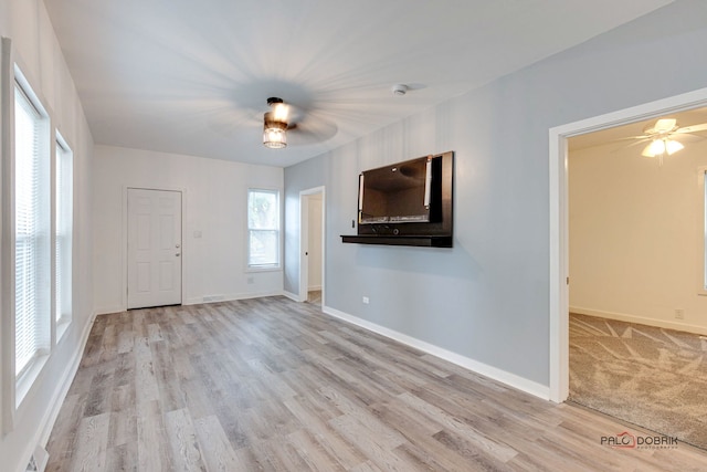 unfurnished living room with ceiling fan and light wood-type flooring