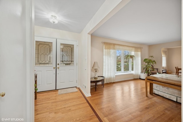 foyer entrance with light hardwood / wood-style floors