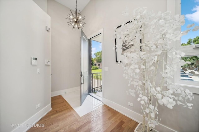 entryway featuring hardwood / wood-style floors and a notable chandelier