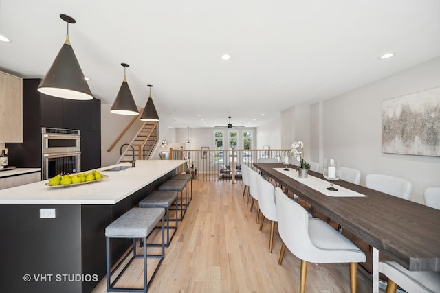 interior space featuring ceiling fan, sink, and light hardwood / wood-style flooring