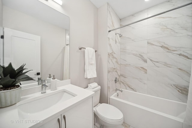 full bathroom with vanity, tiled shower / bath combo, and toilet