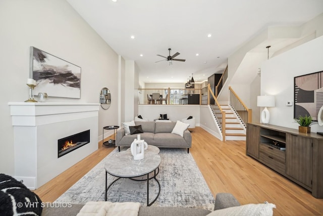 living room featuring ceiling fan and light wood-type flooring