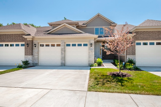 view of front of property with a garage and a front yard