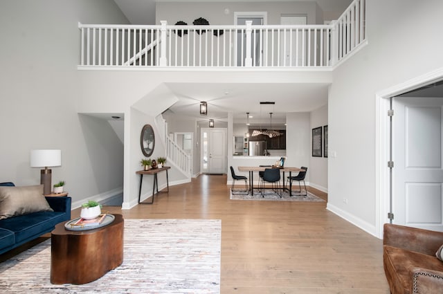 living room featuring hardwood / wood-style floors and a towering ceiling