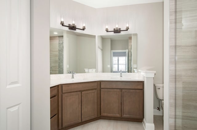 bathroom with a shower, vanity, toilet, and tile patterned flooring