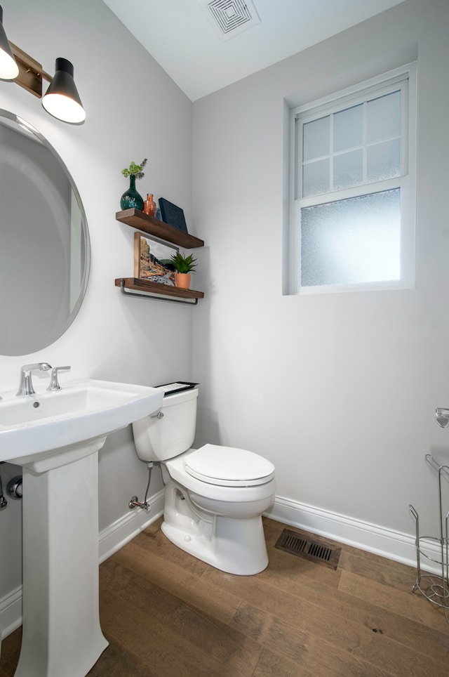 bathroom featuring hardwood / wood-style floors, toilet, and sink