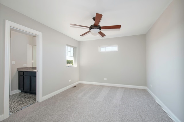 carpeted empty room featuring ceiling fan