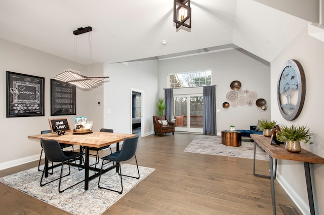 dining room featuring hardwood / wood-style floors and high vaulted ceiling