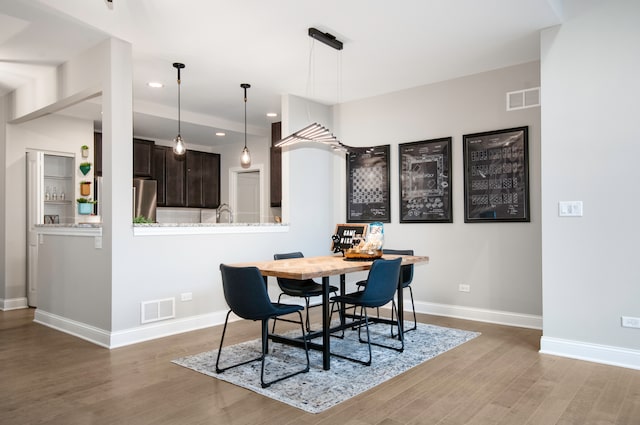 dining space with hardwood / wood-style floors