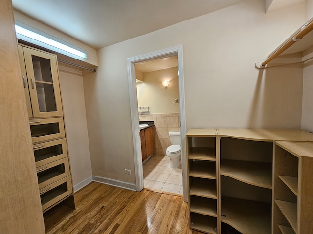 spacious closet with hardwood / wood-style floors