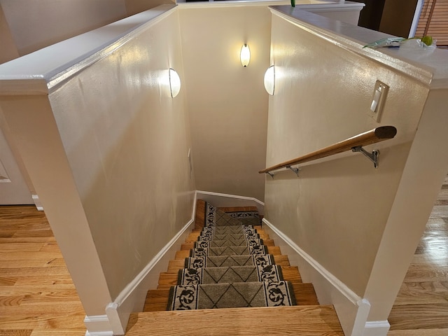 stairs featuring hardwood / wood-style floors