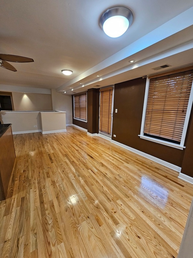 interior space with ceiling fan and light hardwood / wood-style flooring