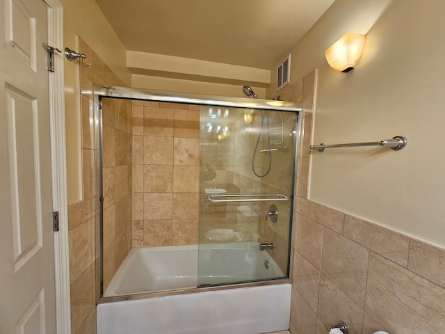 bathroom featuring shower / bath combination with glass door