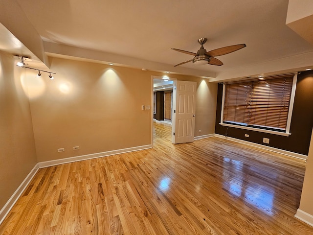 empty room featuring ceiling fan and light wood-type flooring