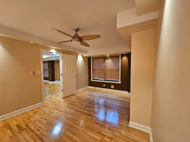 spare room featuring light hardwood / wood-style flooring and ceiling fan