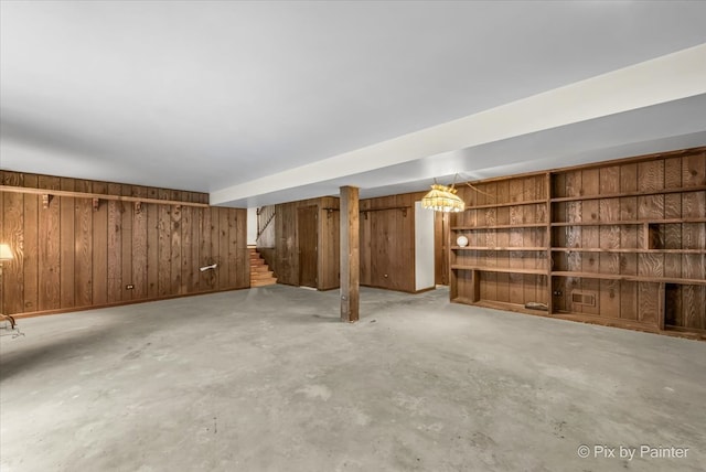 basement featuring wood walls