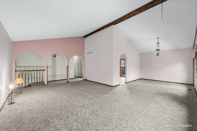 unfurnished living room with carpet flooring, beamed ceiling, and high vaulted ceiling