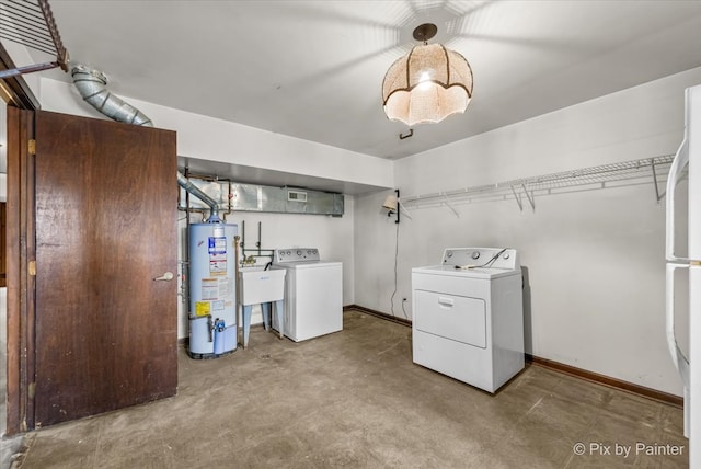 laundry area with water heater, washer and clothes dryer, and sink