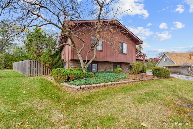 view of side of home with a lawn