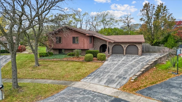 view of front of house with a garage and a front lawn