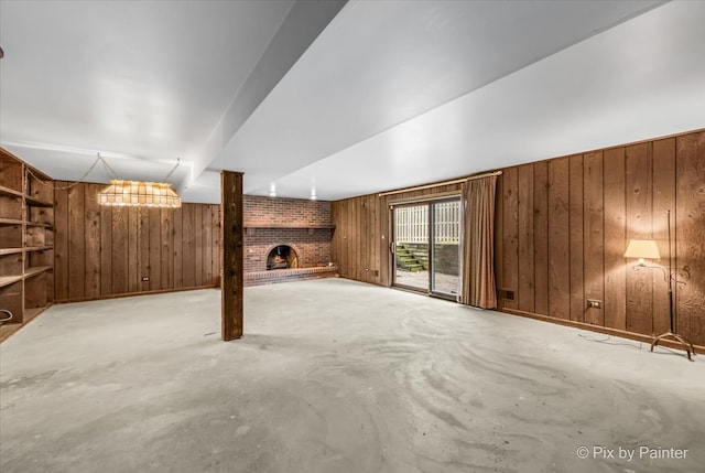 basement featuring a fireplace and wooden walls