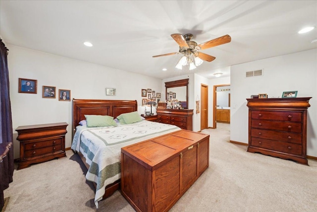 carpeted bedroom featuring ensuite bathroom and ceiling fan