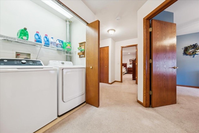 laundry room featuring washing machine and dryer and light colored carpet