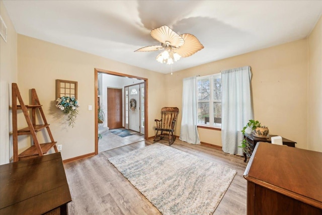 sitting room featuring light hardwood / wood-style floors and ceiling fan