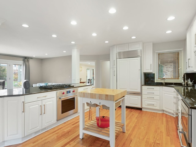 kitchen featuring white cabinets and stainless steel oven