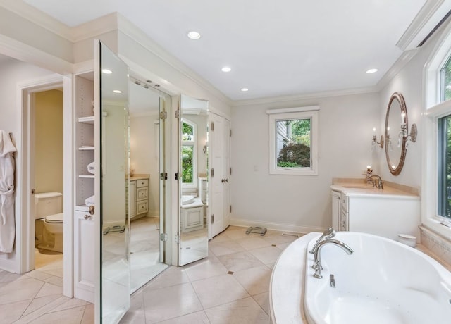 bathroom featuring vanity, tile patterned floors, crown molding, a washtub, and toilet