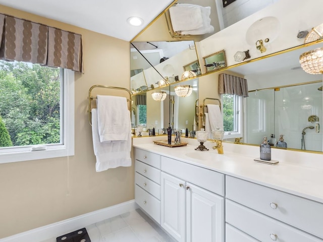 bathroom with tile patterned floors, plenty of natural light, walk in shower, and vanity