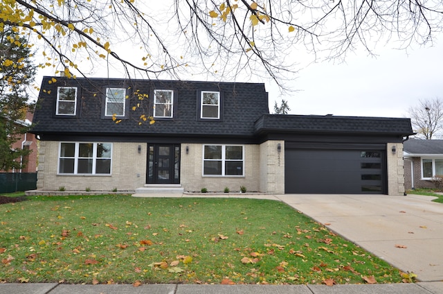 view of front of home featuring a garage and a front lawn