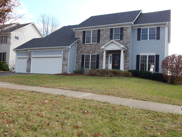 colonial house with a front yard and a garage