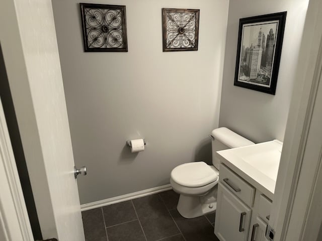 bathroom featuring tile patterned floors, vanity, and toilet