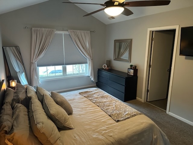 carpeted bedroom with vaulted ceiling and ceiling fan