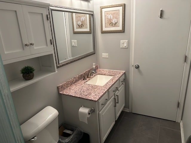 bathroom featuring tile patterned flooring, vanity, and toilet