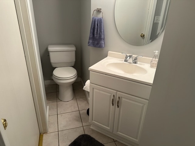 bathroom featuring tile patterned flooring, vanity, and toilet