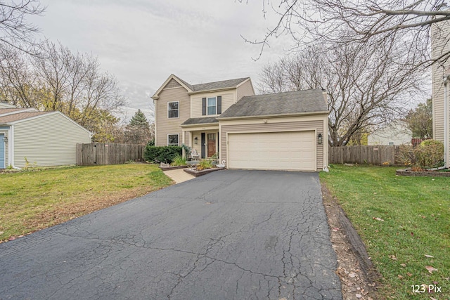 view of front property with a front yard and a garage