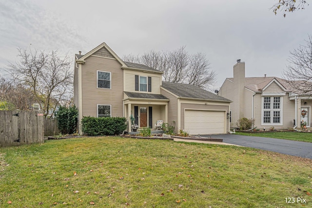 view of front property featuring a garage and a front yard