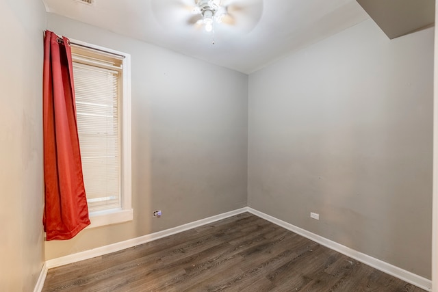 unfurnished room with ceiling fan and dark wood-type flooring