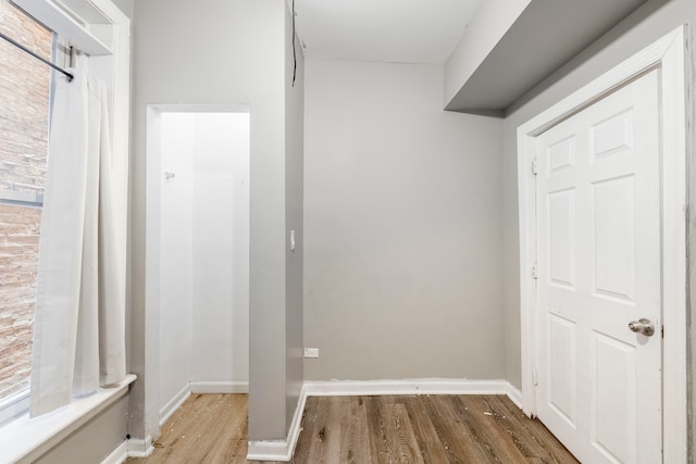 corridor featuring wood-type flooring