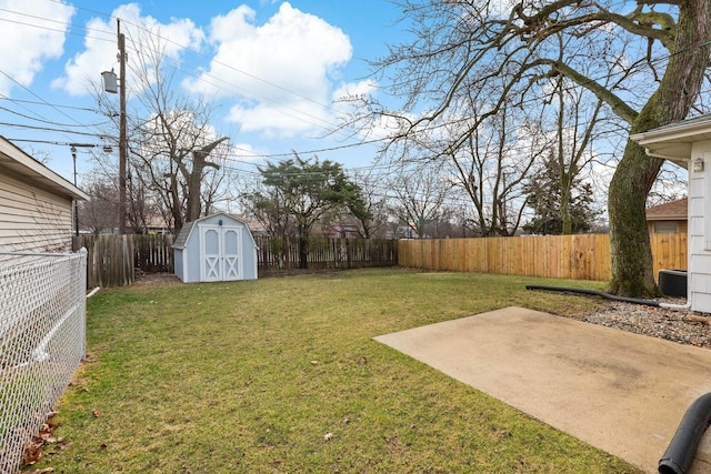 view of yard featuring an outbuilding, a storage shed, a fenced backyard, and a patio area