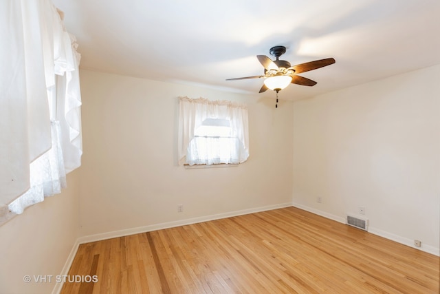 spare room with ceiling fan and light wood-type flooring