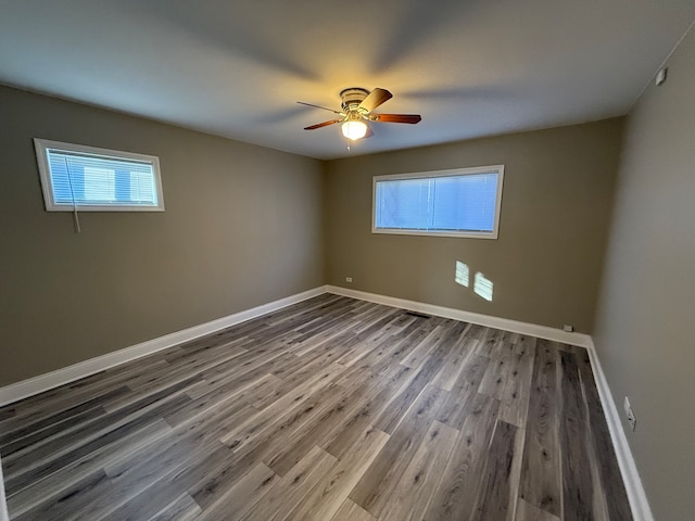 empty room featuring hardwood / wood-style floors and ceiling fan