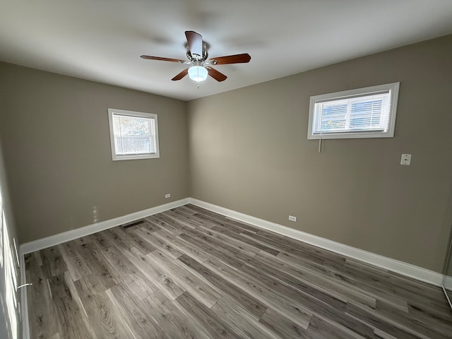 empty room with hardwood / wood-style flooring and ceiling fan