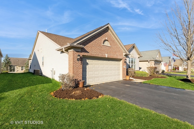 view of property featuring a front yard and a garage