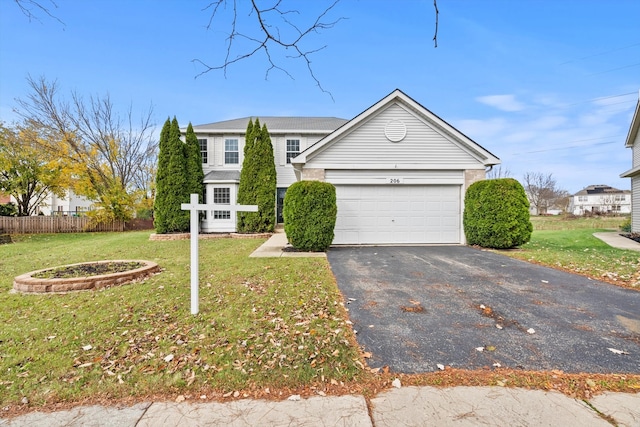 view of front of house with a garage and a front lawn