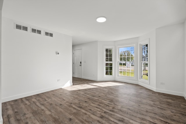 empty room featuring dark hardwood / wood-style flooring